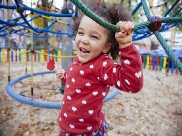 Young African American girl at play with a smile on her face